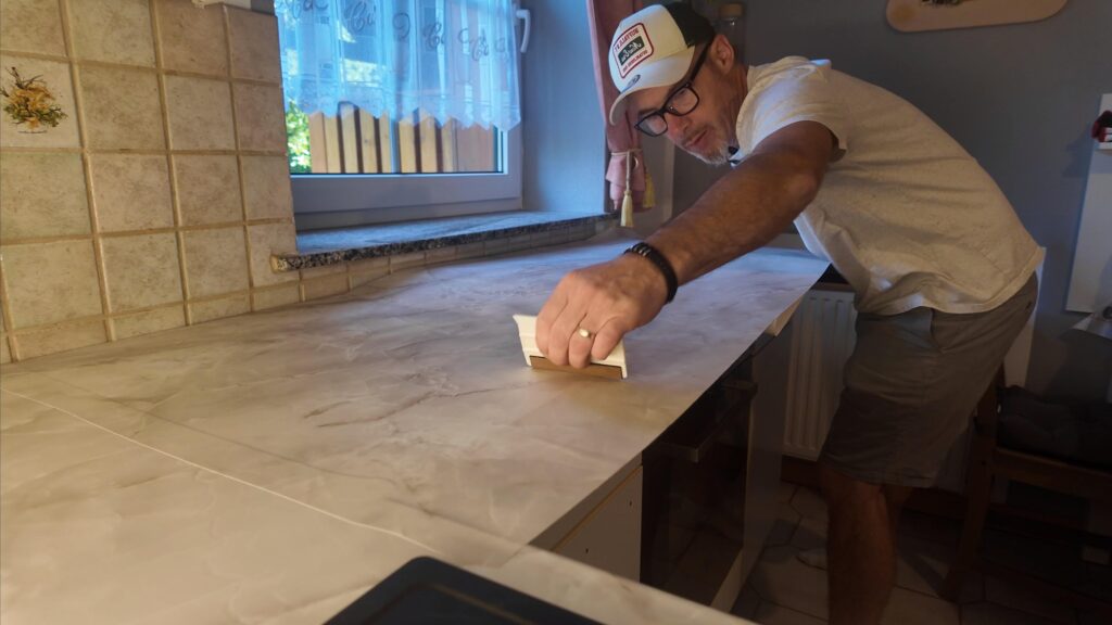 Ronny Wetzel beim Folieren einer Arbeitsplatte - WOMOSTYLE Interior Concepts